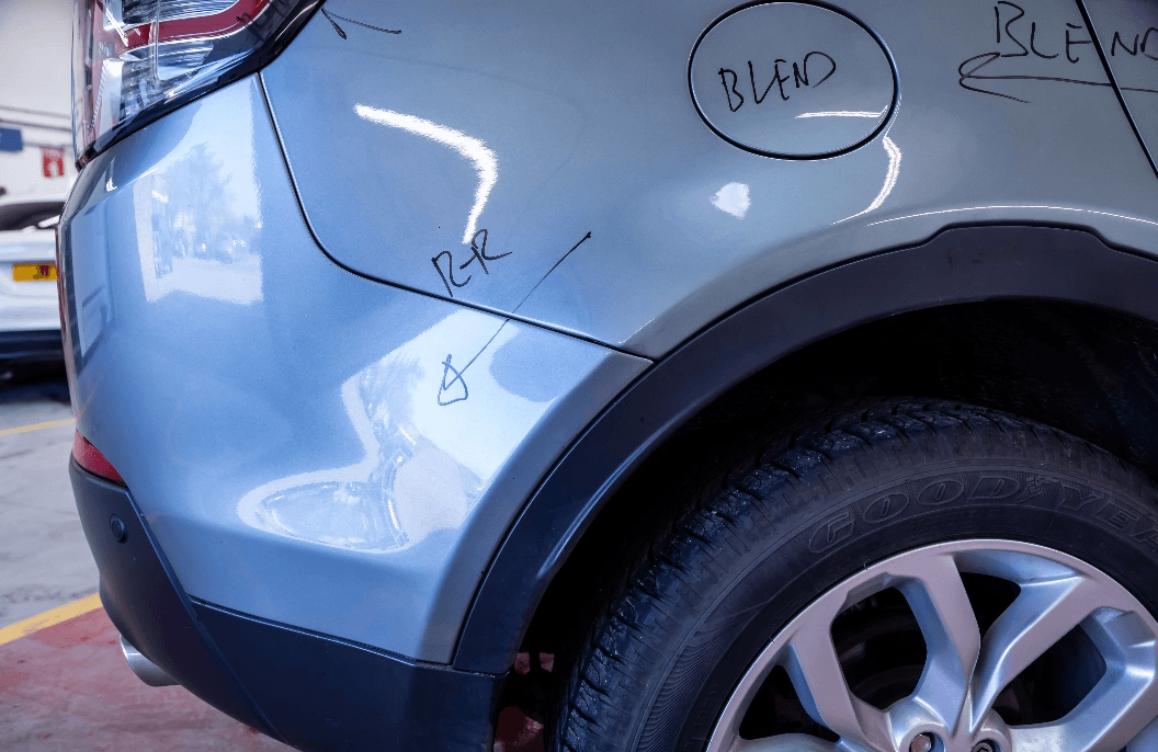 Rear side of car with black markings to show the repairs that will be done