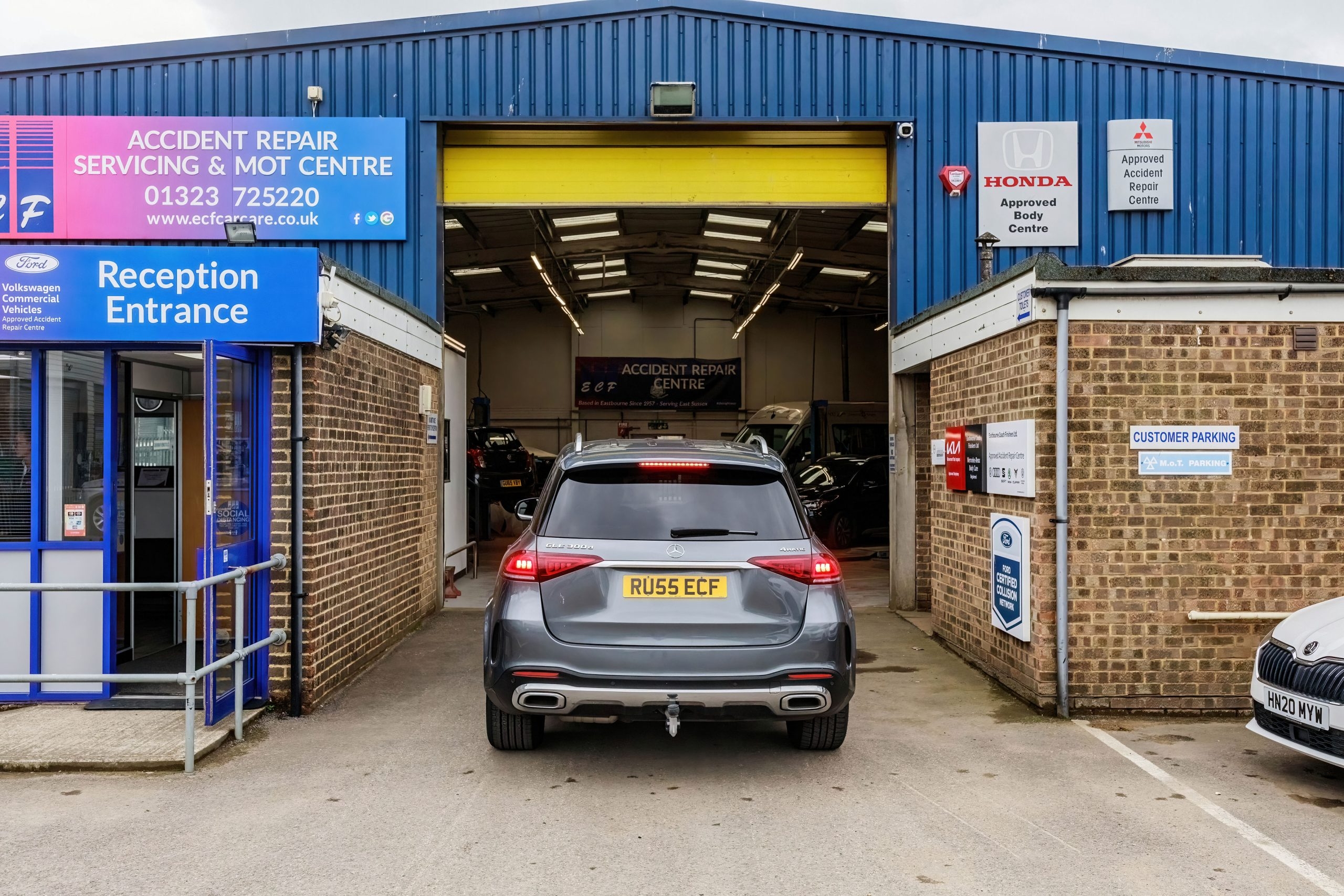 Mercedes - Benz car parked infront of open door of the MOT Eastbourne test centre ECF Car Care